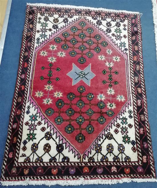 A Persian pink ground rug, with central hexagonal medallion Approx. 140 x 100cm